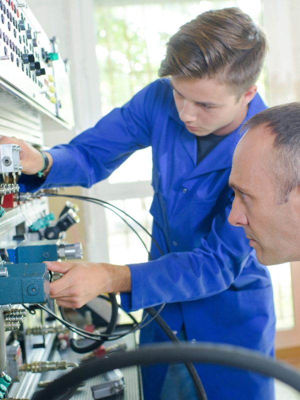 Apprentice electrician under supervision